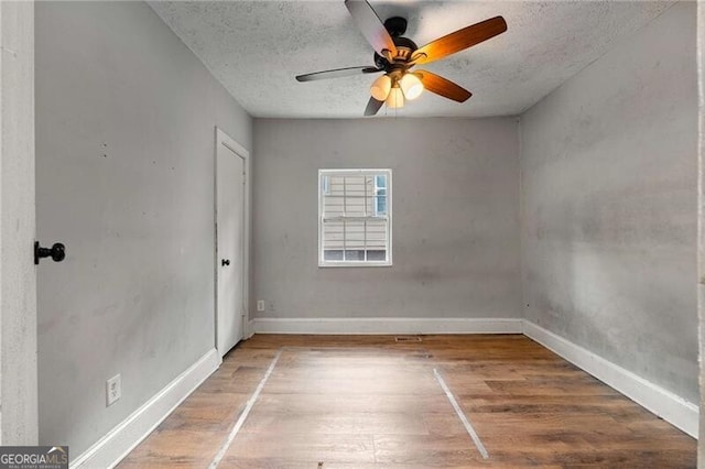 1090 Harwell St NW, Atlanta, GA 30314 - empty room with a textured ceiling, baseboards, ceiling fan, and wood finished floors