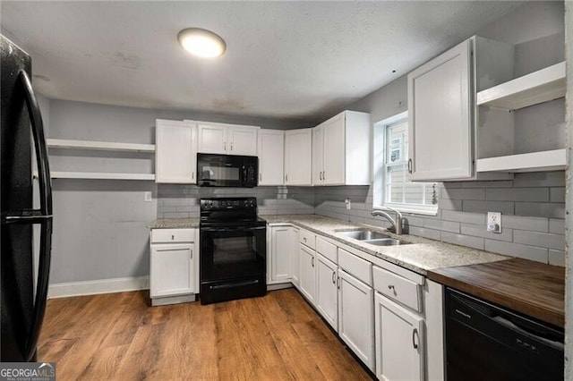 1090 Harwell St NW, Atlanta, GA 30314 - kitchen featuring white cabinetry, black appliances, a sink, and open shelves