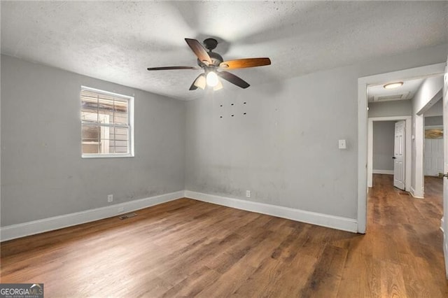1090 Harwell St NW, Atlanta, GA 30314 - unfurnished room featuring a ceiling fan, a textured ceiling, baseboards, and wood finished floors