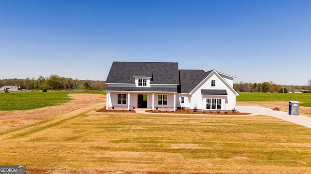 284 Community House Rd, Barnesville, GA 30204 - modern farmhouse style home with a front yard, driveway, covered porch, and a shingled roof