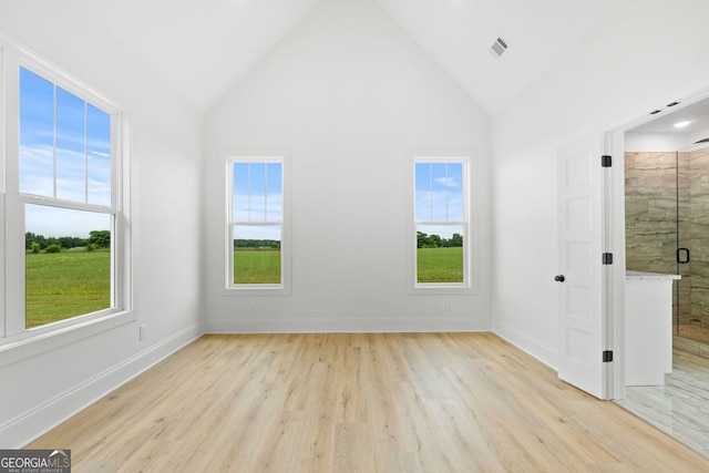 284 Community House Rd, Barnesville, GA 30204 - unfurnished bedroom featuring light wood finished floors, high vaulted ceiling, and ensuite bath