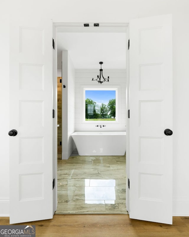 284 Community House Rd, Barnesville, GA 30204 - bathroom featuring a freestanding bath and a chandelier