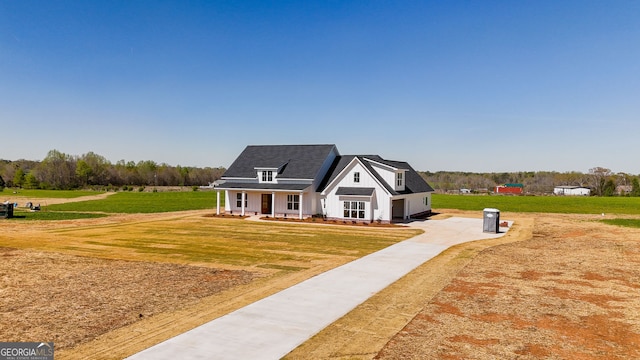 284 Community House Rd, Barnesville, GA 30204 - modern farmhouse style home with driveway, a garage, a front lawn, and a porch