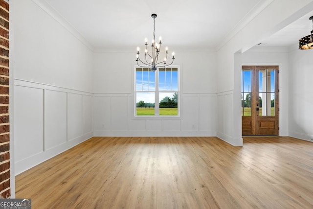 284 Community House Rd, Barnesville, GA 30204 - unfurnished dining area with a chandelier, healthy amount of natural light, wood finished floors, a decorative wall, and wainscoting