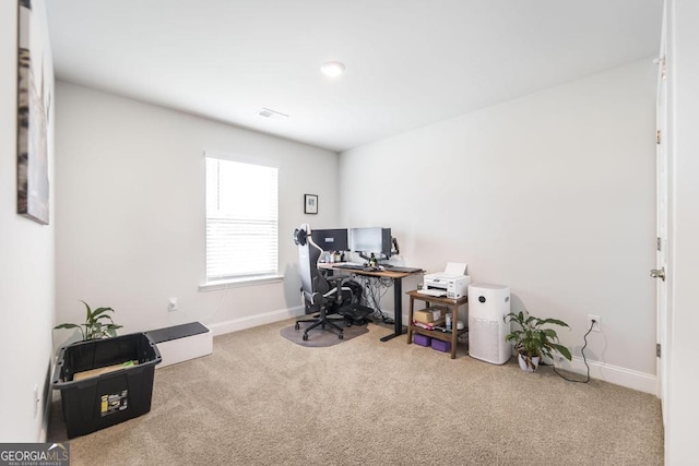 carpeted office with visible vents and baseboards