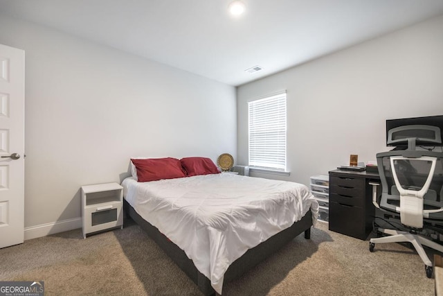 carpeted bedroom with visible vents and baseboards