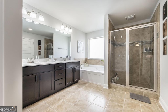 bathroom featuring double vanity, tile patterned flooring, a shower stall, a bath, and a sink