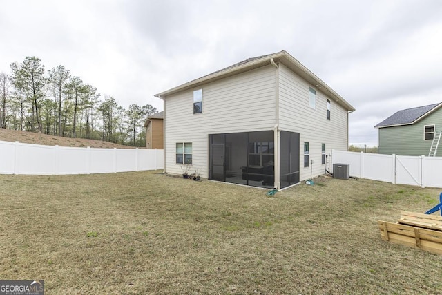 rear view of property featuring a yard, a fenced backyard, cooling unit, and a sunroom
