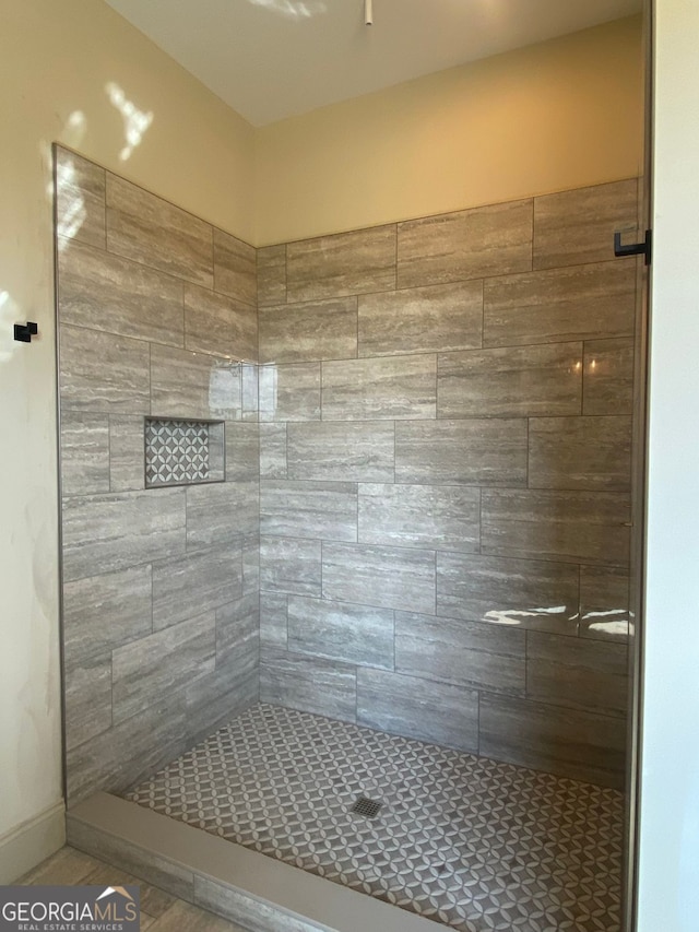 bathroom with a tile shower