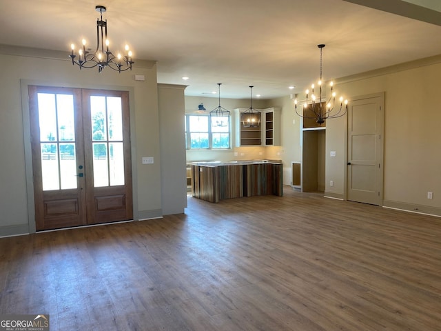 interior space with an inviting chandelier, dark wood-type flooring, and french doors