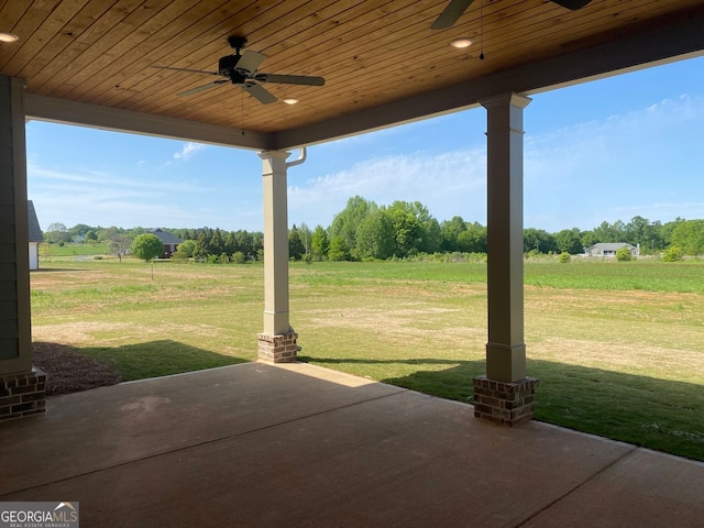 view of patio / terrace with ceiling fan and a rural view