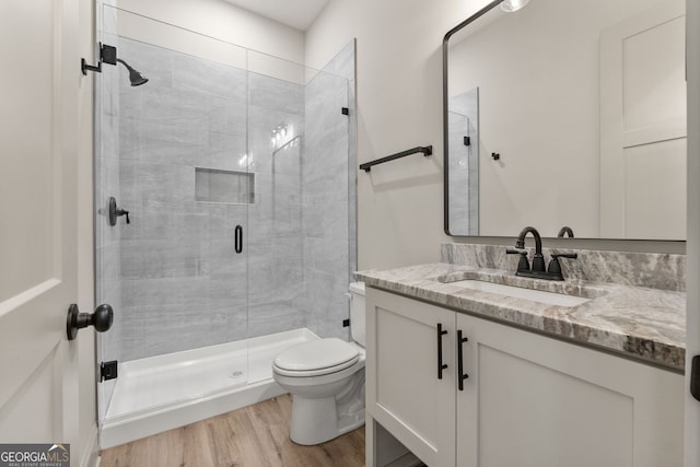 272 Community House Rd, Barnesville, GA 30204 - full bathroom with vanity, toilet, wood finished floors, and a stall shower