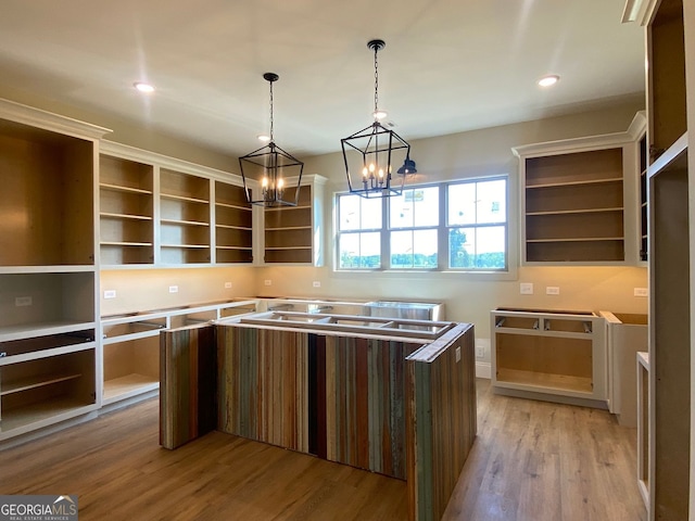 kitchen with open shelves, hanging light fixtures, light wood-style floors, a center island, and recessed lighting