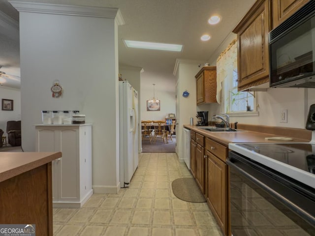 2188 Hi Roc Cir, Conyers, GA 30012 - kitchen featuring a sink, crown molding, black appliances, and brown cabinets