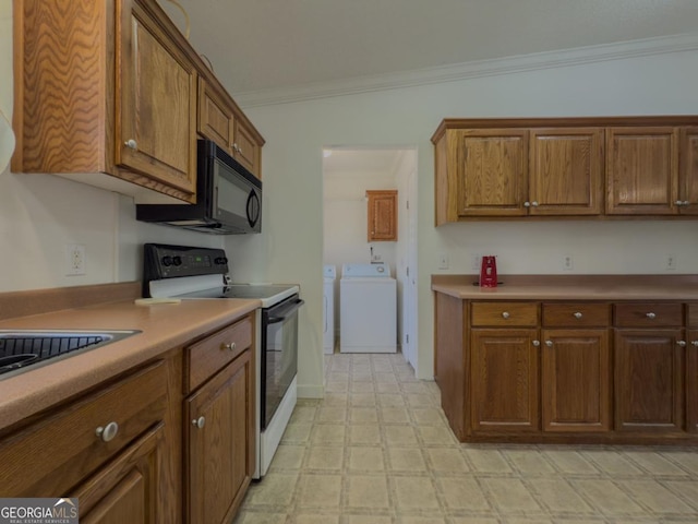 2188 Hi Roc Cir, Conyers, GA 30012 - kitchen with crown molding, brown cabinets, black microwave, white range with electric cooktop, and washer and clothes dryer