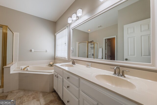 full bathroom featuring a garden tub, a sink, a stall shower, and double vanity