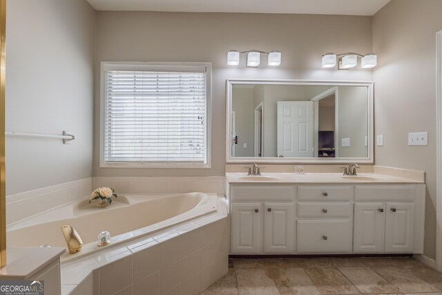 bathroom featuring a sink, a garden tub, and double vanity