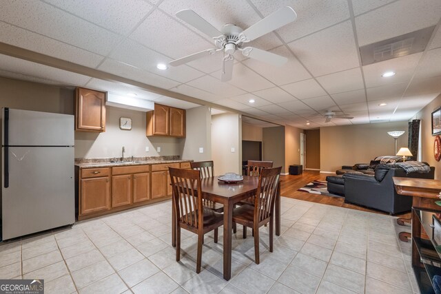dining room featuring a paneled ceiling, a ceiling fan, wet bar, recessed lighting, and light tile patterned floors