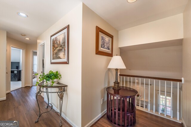 hallway with a healthy amount of sunlight, baseboards, recessed lighting, and wood finished floors