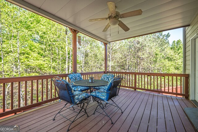 wooden deck featuring ceiling fan and outdoor dining space