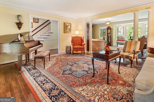 812 Burning Tree Ct SE, Marietta, GA 30067 - living room featuring ornamental molding, decorative columns, wood finished floors, baseboards, and stairs