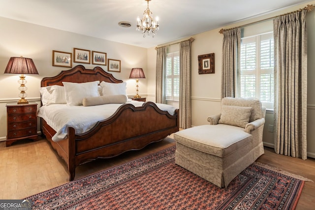 812 Burning Tree Ct SE, Marietta, GA 30067 - bedroom with wood finished floors, multiple windows, a chandelier, and baseboards