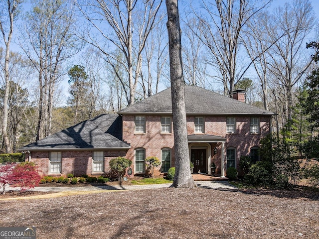 812 Burning Tree Ct SE, Marietta, GA 30067 - colonial home with brick siding, a chimney, and roof with shingles