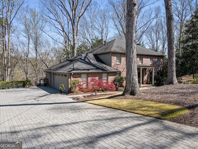 812 Burning Tree Ct SE, Marietta, GA 30067 - traditional-style house with decorative driveway, an attached garage, and brick siding