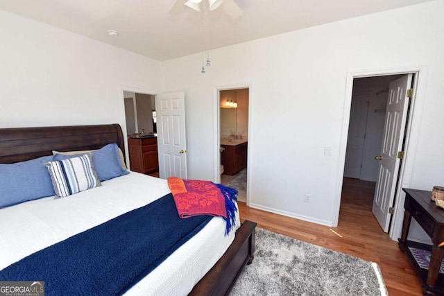 47 Hidden Fields Rd, Hiawassee, GA 30546 - bedroom featuring baseboards, wood finished floors, ceiling fan, and ensuite bathroom