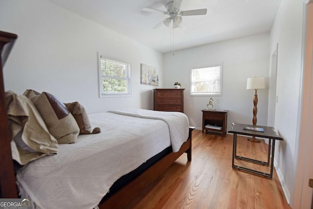 47 Hidden Fields Rd, Hiawassee, GA 30546 - bedroom with wood finished floors, ceiling fan, and multiple windows