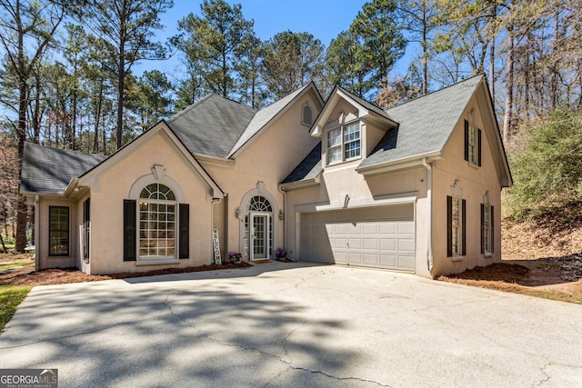 5163 Holly Springs Dr, Douglasville, GA 30135 - view of front of home featuring stucco siding, concrete driveway, and roof with shingles