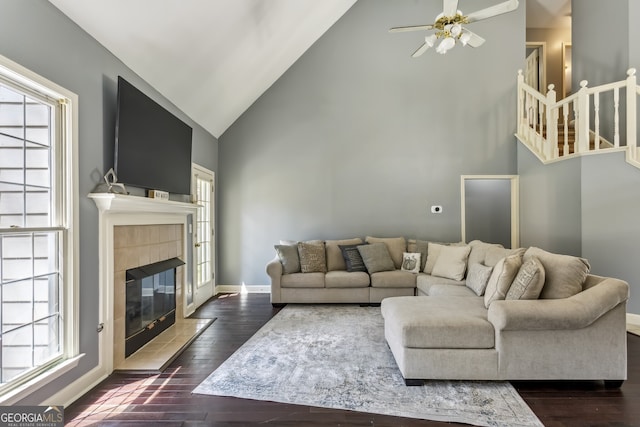 5163 Holly Springs Dr, Douglasville, GA 30135 - living area with high vaulted ceiling, a ceiling fan, a fireplace, dark wood finished floors, and baseboards