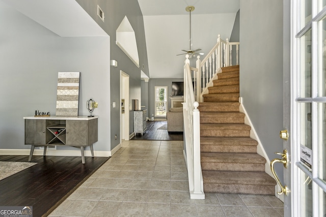 5163 Holly Springs Dr, Douglasville, GA 30135 - foyer with visible vents, baseboards, stairs, ceiling fan, and wood finished floors