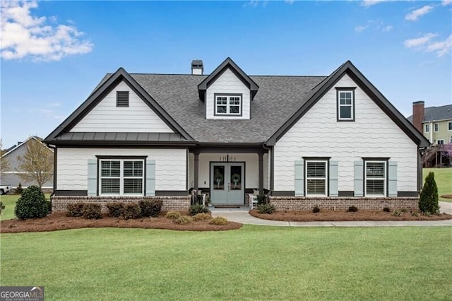 50 Harmony Grove Ln, Jefferson, GA 30549 - view of front facade with french doors, brick siding, a front yard, and roof with shingles