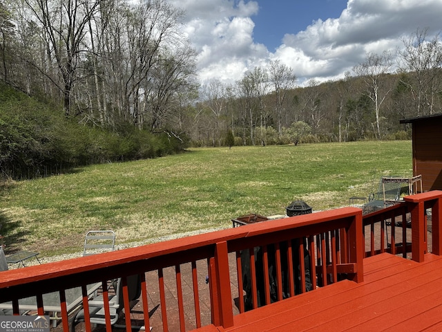 88 Fishtail Cir, Cleveland, GA 30528 - wooden terrace featuring a lawn, a view of trees, and an outdoor fire pit