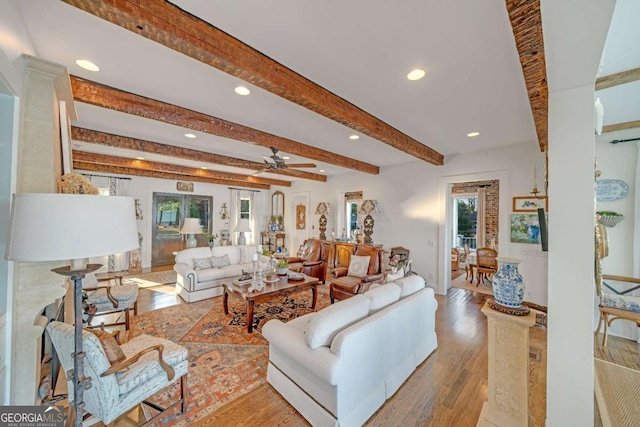 living area featuring beamed ceiling, wood finished floors, recessed lighting, and a ceiling fan