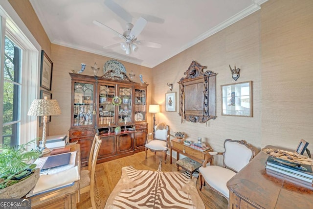 living area featuring crown molding, wood finished floors, and ceiling fan