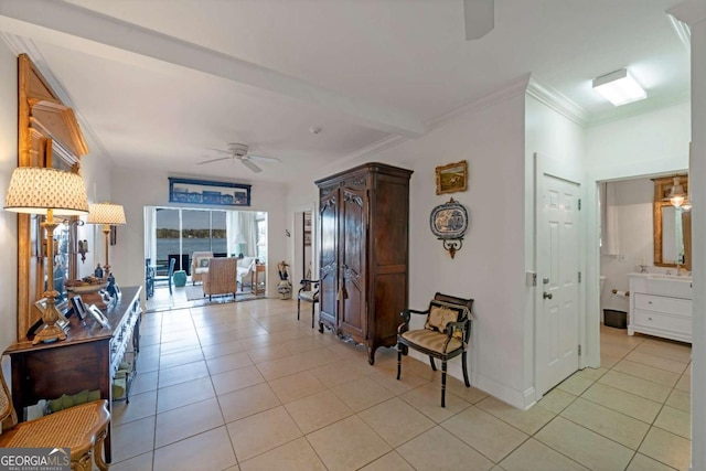 interior space with light tile patterned floors, ornamental molding, and baseboards