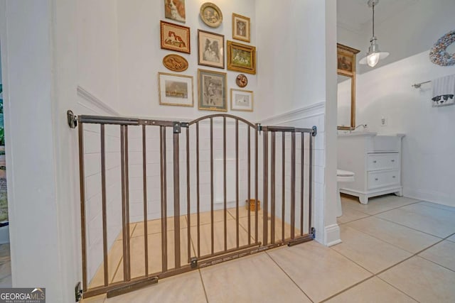staircase featuring baseboards and tile patterned flooring