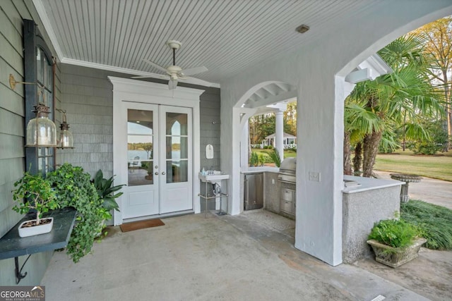 doorway to property featuring ceiling fan, french doors, and an outdoor kitchen