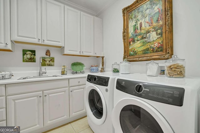 laundry room featuring crown molding, independent washer and dryer, light tile patterned floors, a sink, and cabinet space