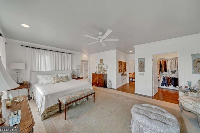 bedroom with ornamental molding, recessed lighting, a spacious closet, and ceiling fan