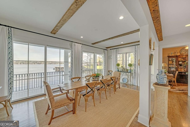 dining area with baseboards, light wood-style flooring, recessed lighting, and beamed ceiling
