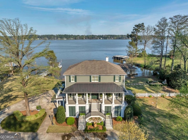 view of front facade featuring a water view, covered porch, and stairway