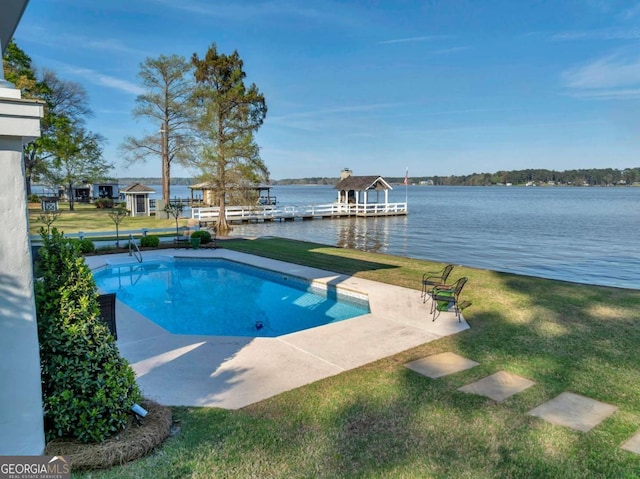 view of swimming pool featuring a boat dock, a water view, a yard, and a patio