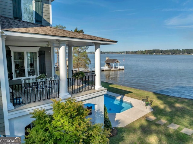 view of swimming pool featuring a water view and a patio area