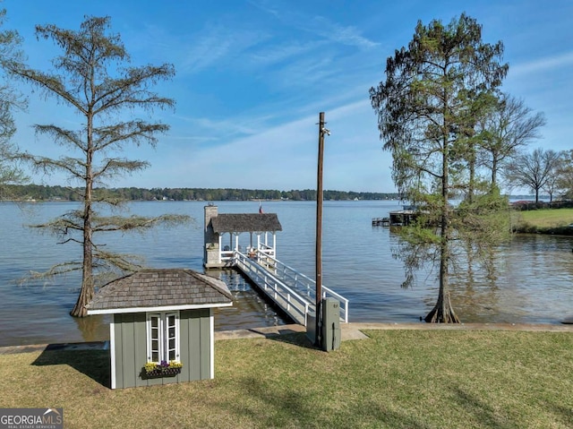 view of dock featuring a water view and a yard