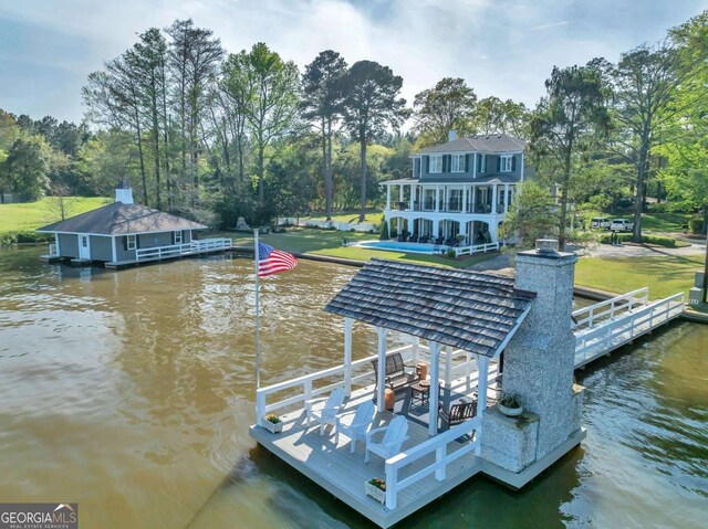 dock area featuring a water view and a yard