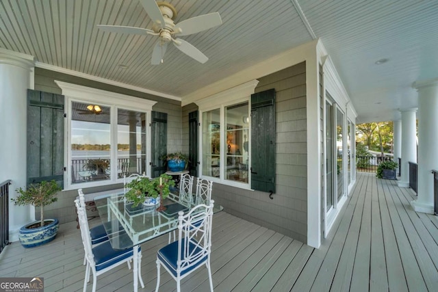 wooden terrace with a porch and ceiling fan