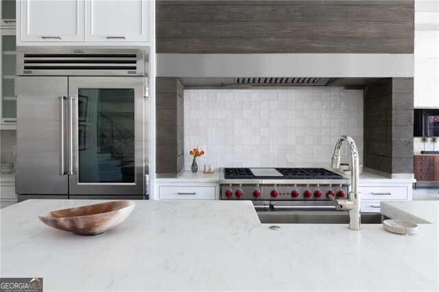 5495 Mount Vernon Pkwy, Atlanta, GA 30327 - kitchen with baseboards, a sink, built in fridge, and beamed ceiling
